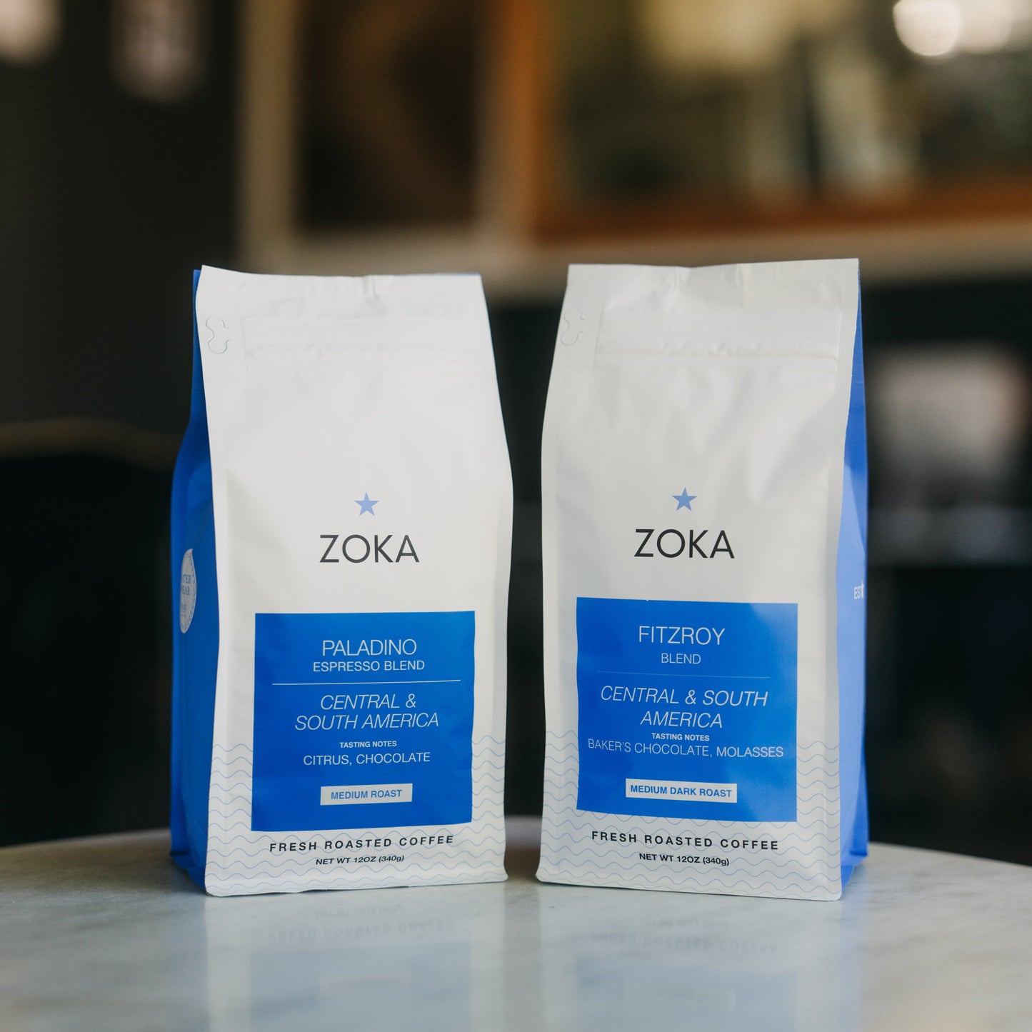 One 12 oz bag of Paladino blend and one 12 oz bag of Fitzroy blend on a table.