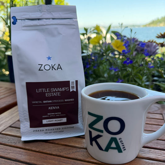 Bag of Little Swamps coffee on a table outside next to a mug of coffee